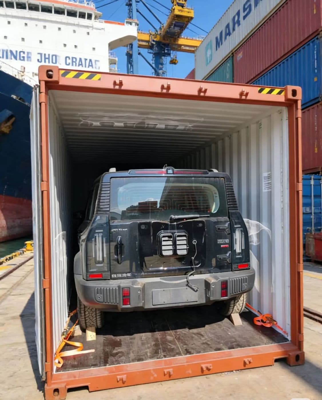 suv loaded in shipping container